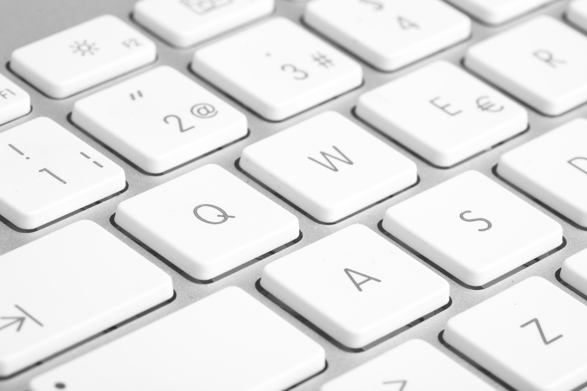 extreme closeup of a modern silver keyboard